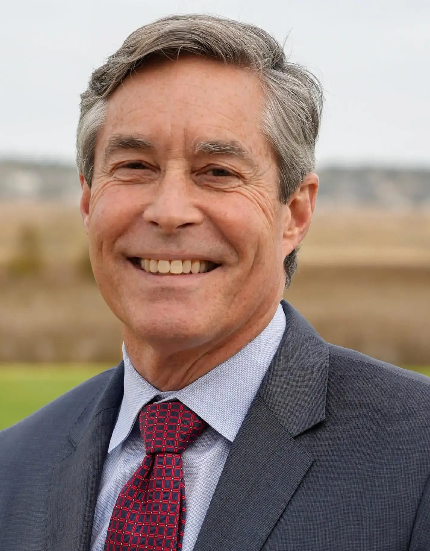 Smiling older man wearing suit and tie