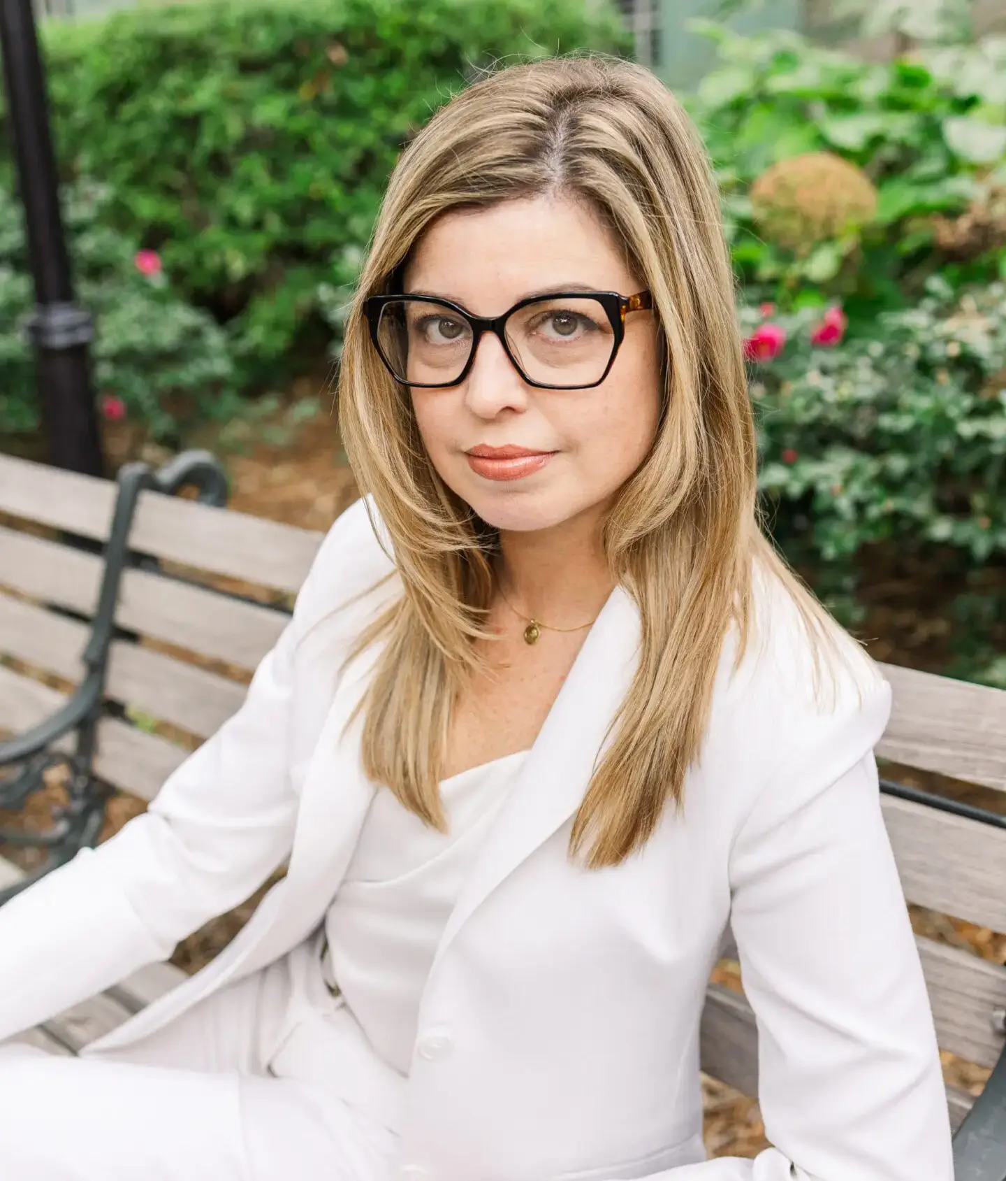 Woman with glasses in white blazer